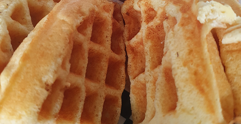 A close-up of two waffles.